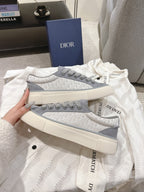 Gray Dior unisex lace-up sneakers close-up, side logo trim and thick sole