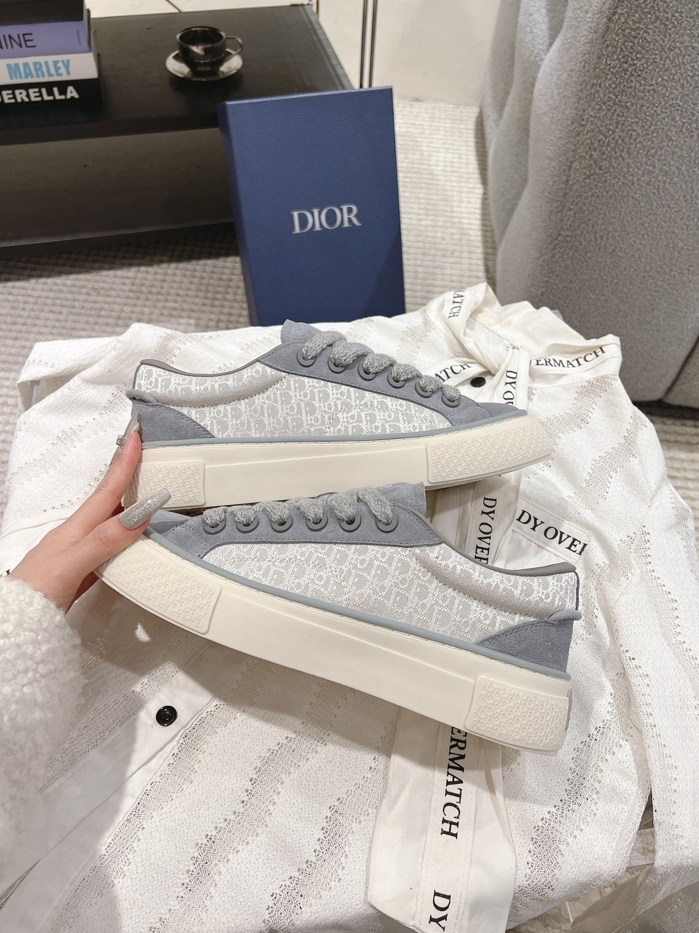 Gray Dior unisex lace-up sneakers close-up, side logo trim and thick sole