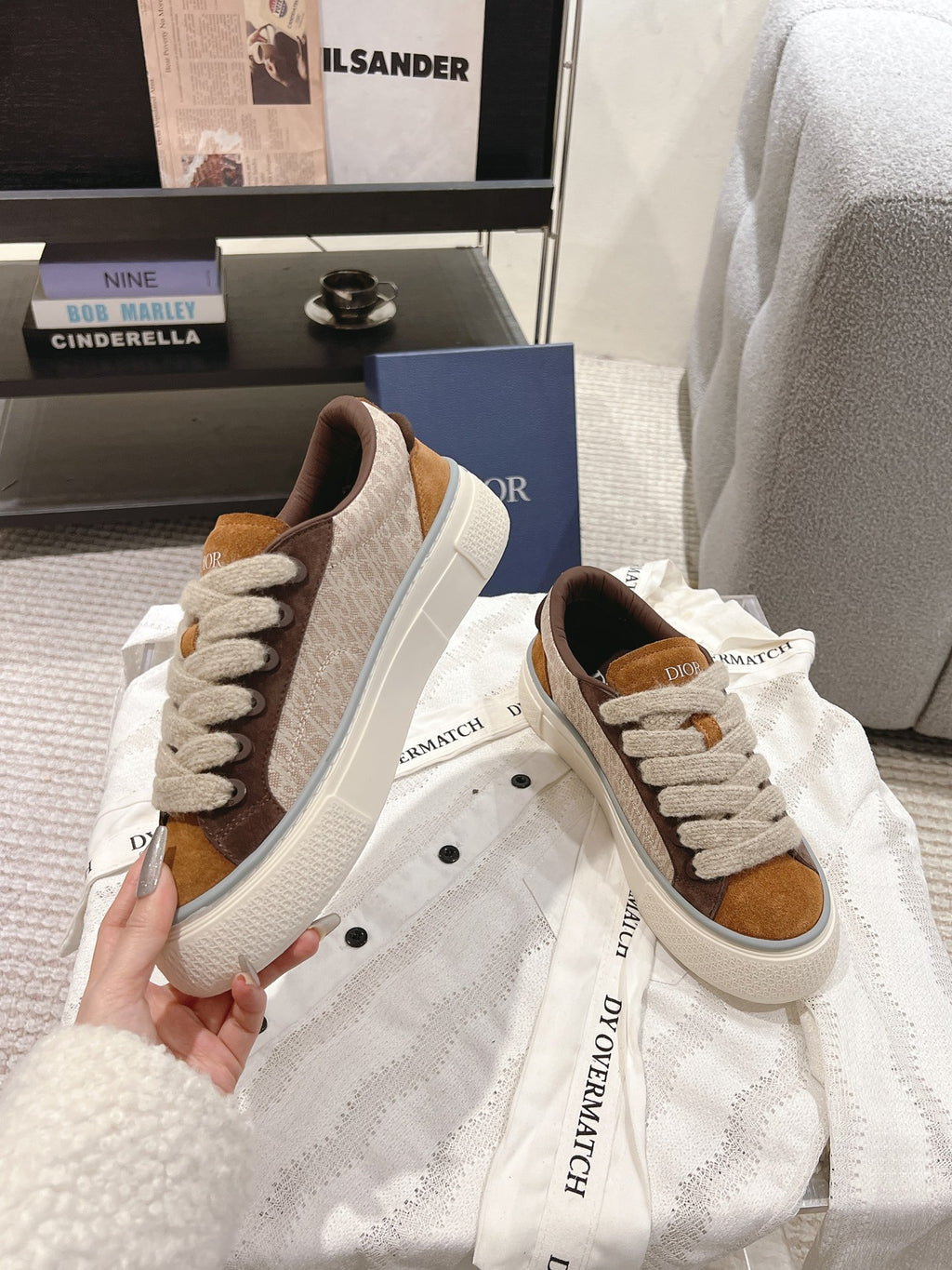 Pair of white and tan low-top sneakers with brown suede panels and lace-up front