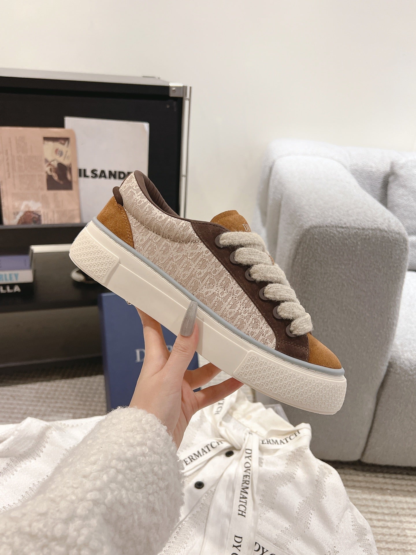 Brown and beige low-top sneakers with textured upper, lace-up closure, white sole