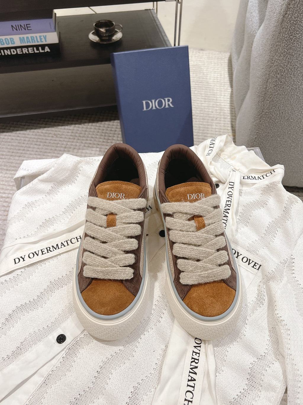 Pair of beige and brown low-top sneakers with white rubber sole and lace-up front