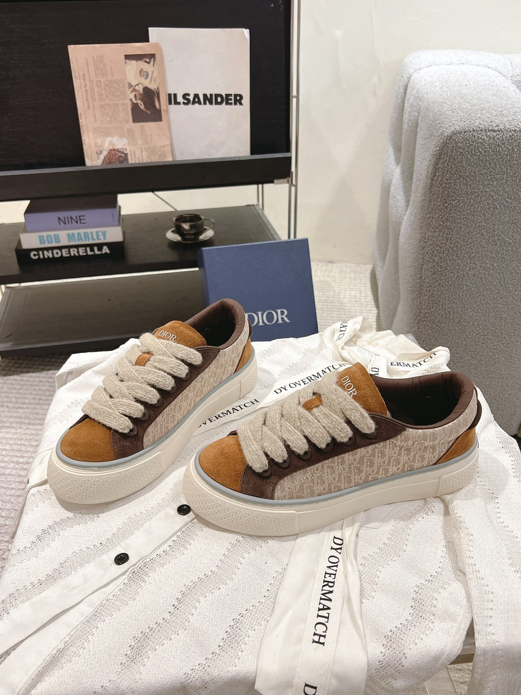 Low-top sneakers in tan, brown and beige with white laces and side branding patch