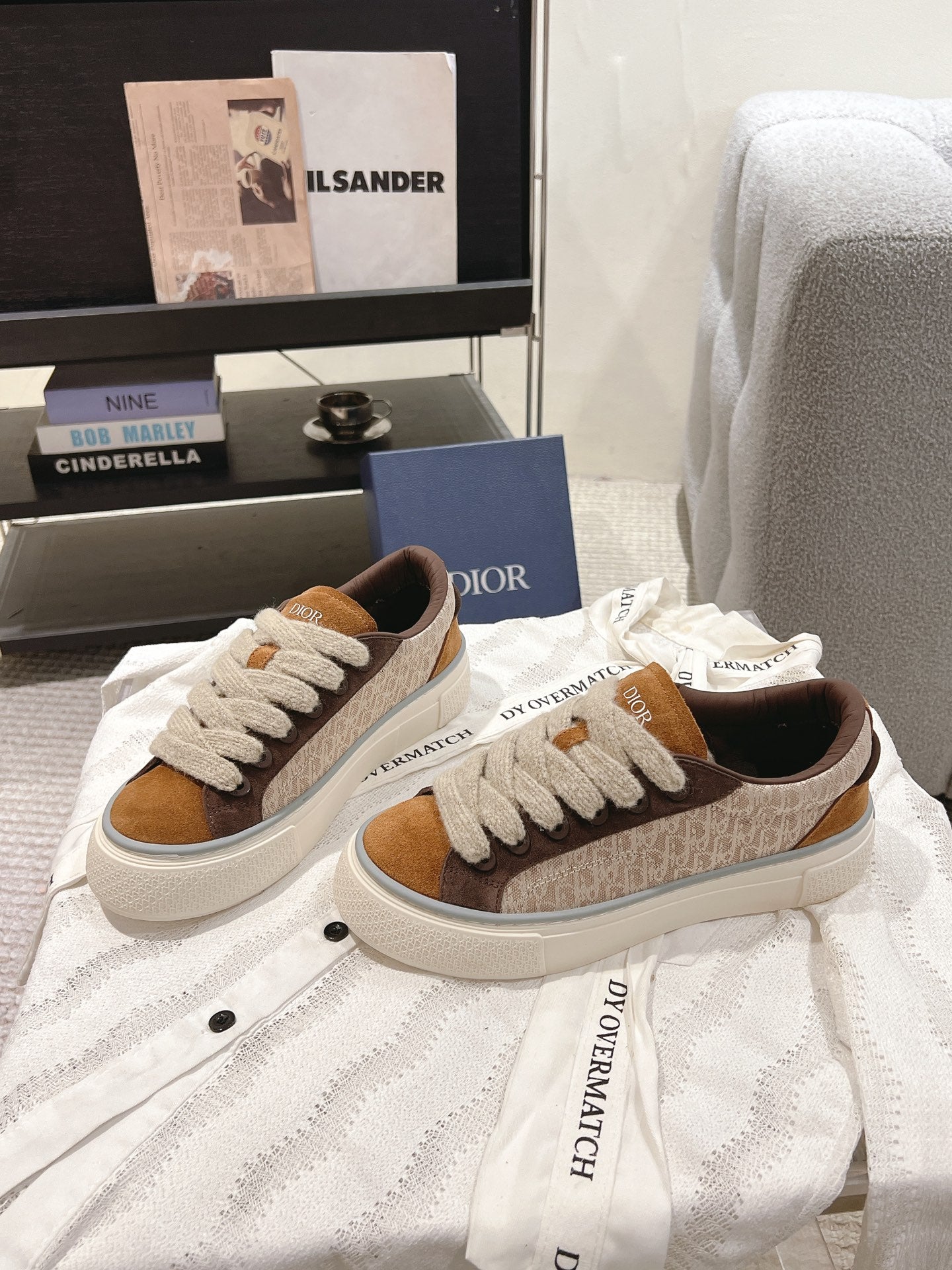 Low-top sneakers in tan, brown and beige with white laces and side branding patch