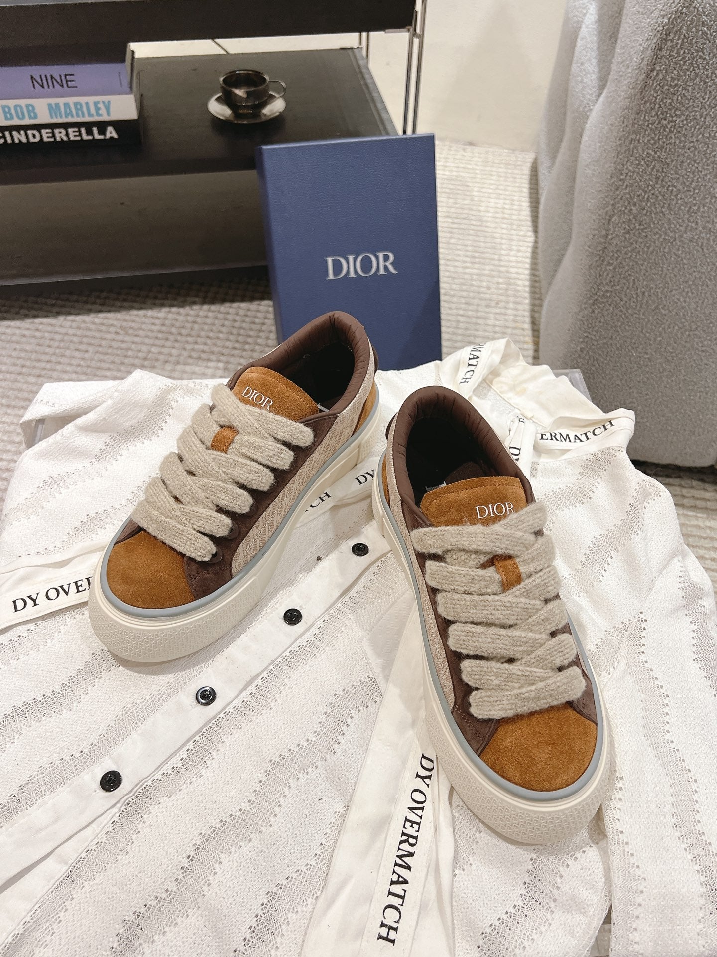Tan and brown low-top sneakers with white laces and Dior logo tongue label