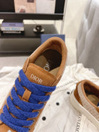 Back view of tan sneaker showing blue laces and DIOR heel tab
