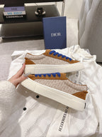 Brown-and-tan sneakers with blue laces and white textured side panels
