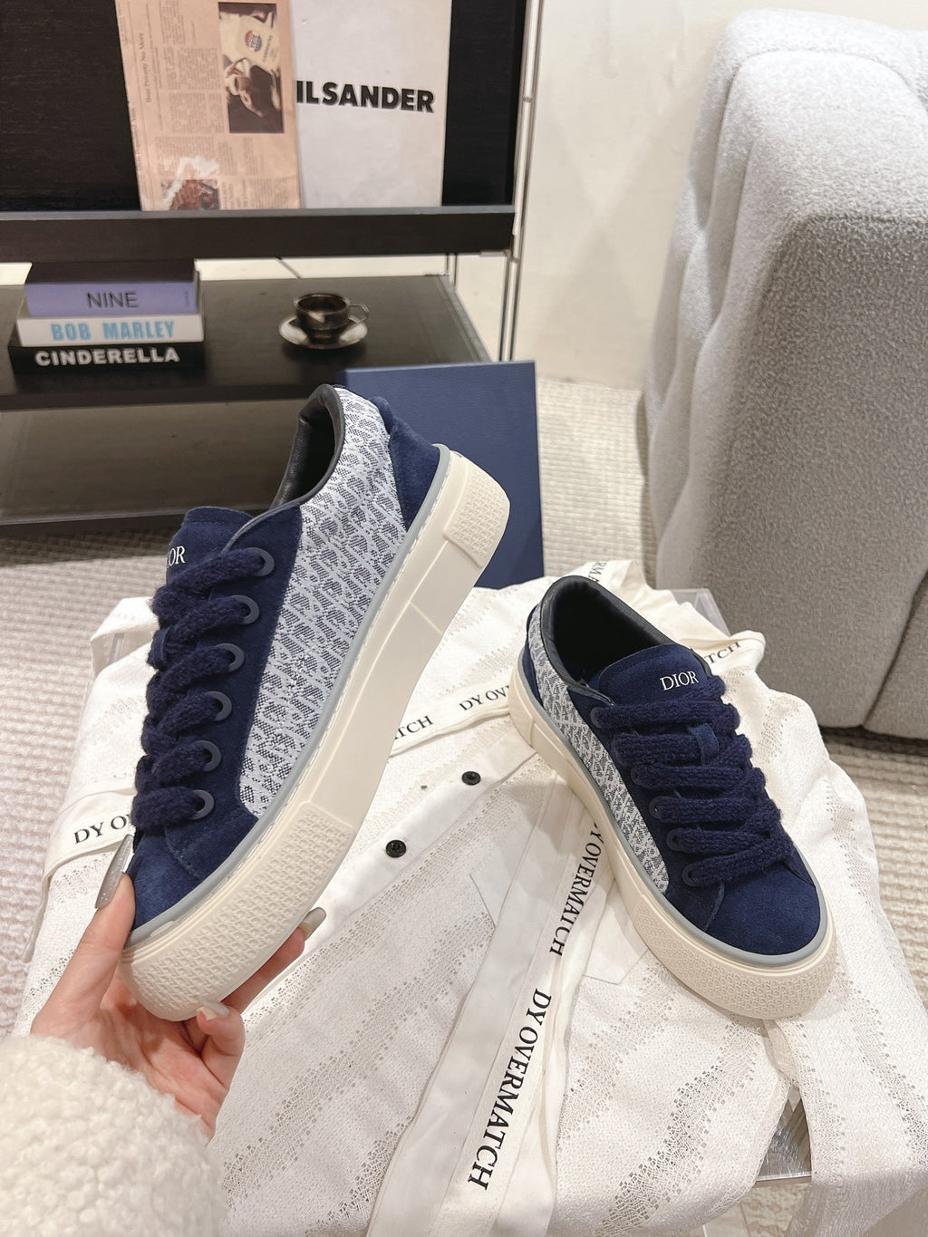 Pair of navy Dior lace-up sneakers with white rubber soles