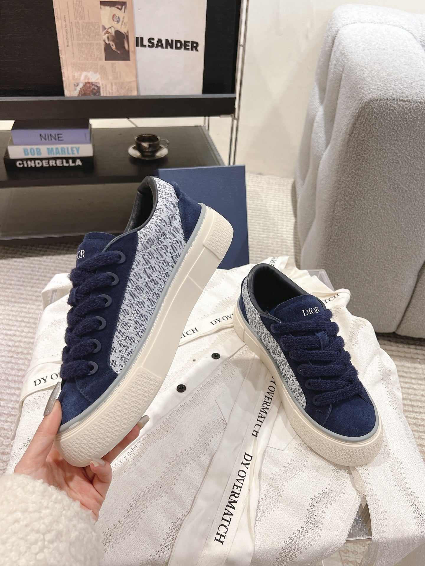 Pair of navy Dior lace-up sneakers with white rubber soles