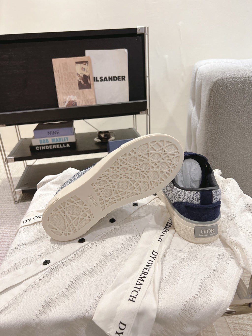 Blue Dior sneakers showing white outsole tread and logo side