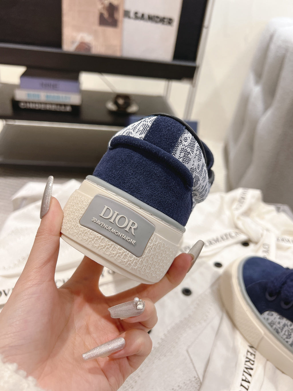 Dior sneaker outsole with navy fabric upper and lace-up opening