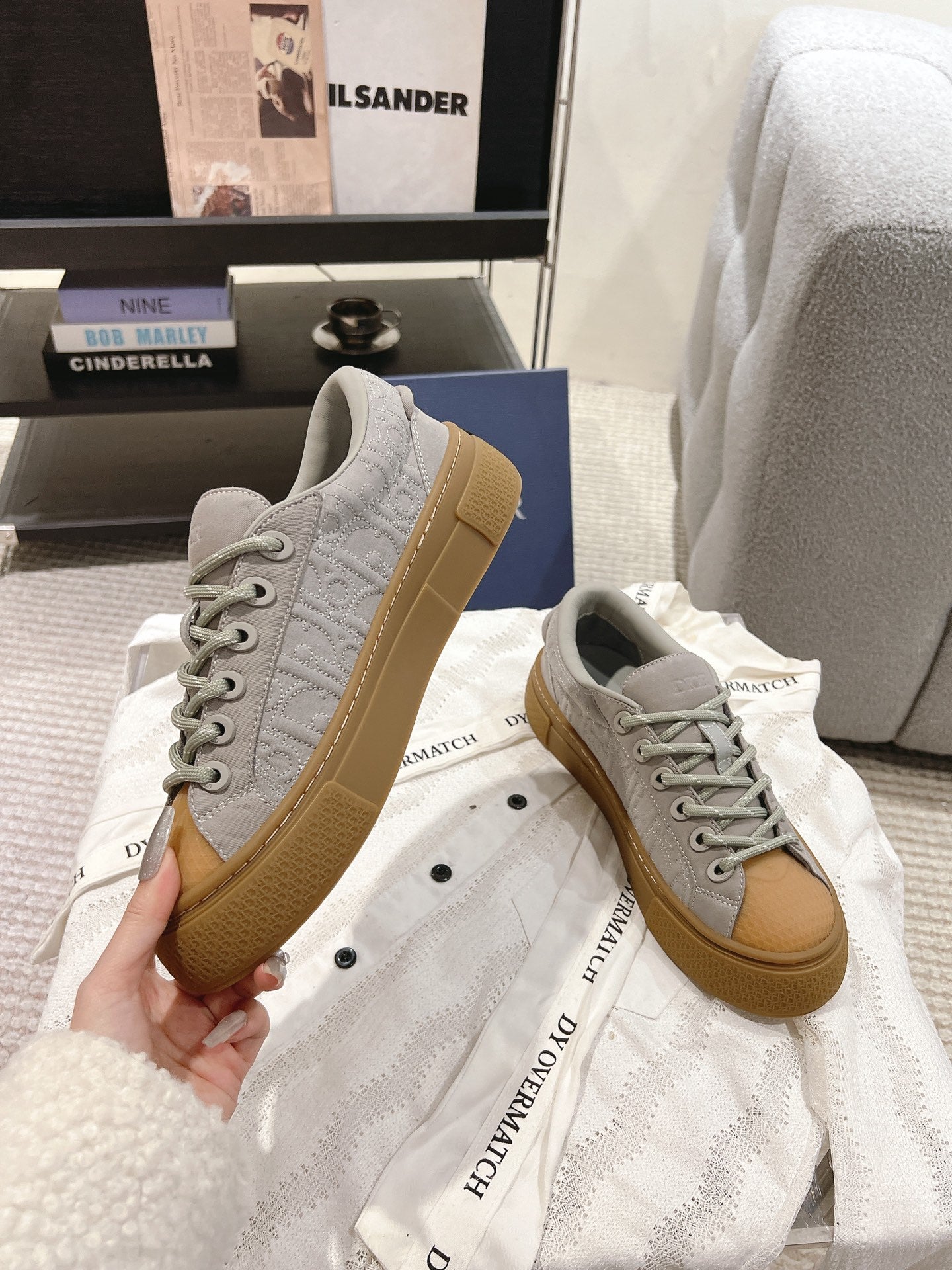 Dior unisex sneakers, light gray leather with tan sole, lace-up front view