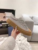 Dior unisex sneaker, light gray upper with tan outsole, lace-up design