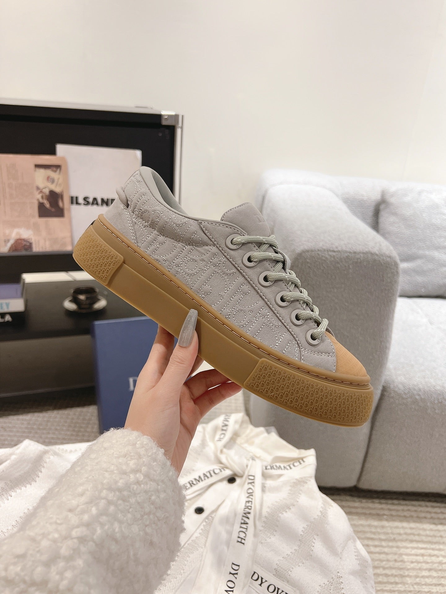 Dior unisex sneaker, light gray upper with tan outsole, lace-up design