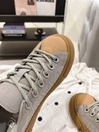 Dior unisex sneaker toe, light gray textured upper with tan rubber sole