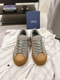 Dior unisex sneakers, light gray leather with tan rubber sole and lace-up eyelets