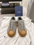 Dior unisex sneakers, light gray leather with tan rubber sole and lace-up eyelets