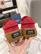 Back view of red sneakers with tan soles, DIOR heel labels visible