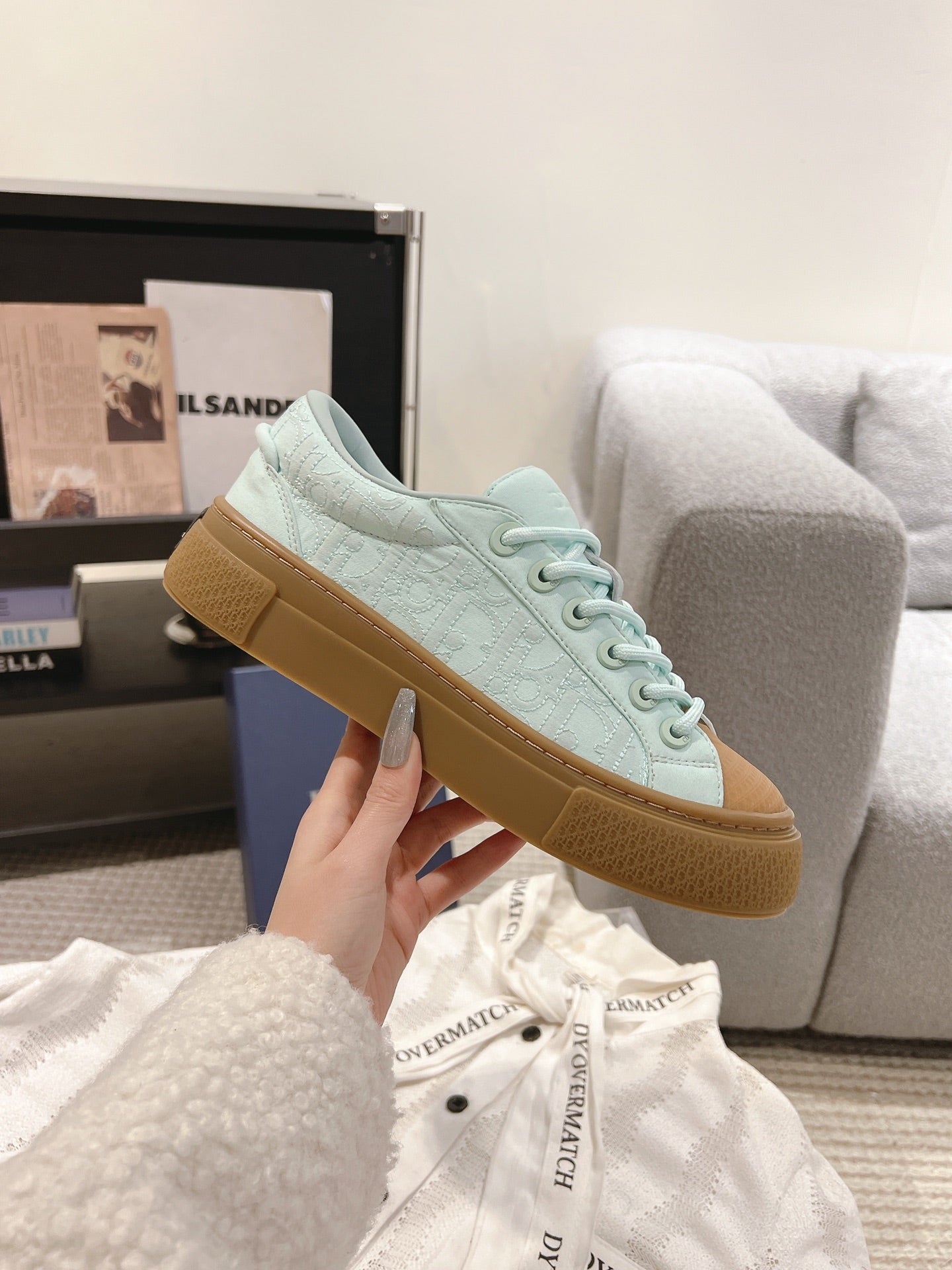 Light blue lace-up sneaker with tan gum sole and perforated side detail