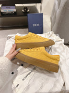 Yellow lace-up low-top unisex sneakers, side and sole view
