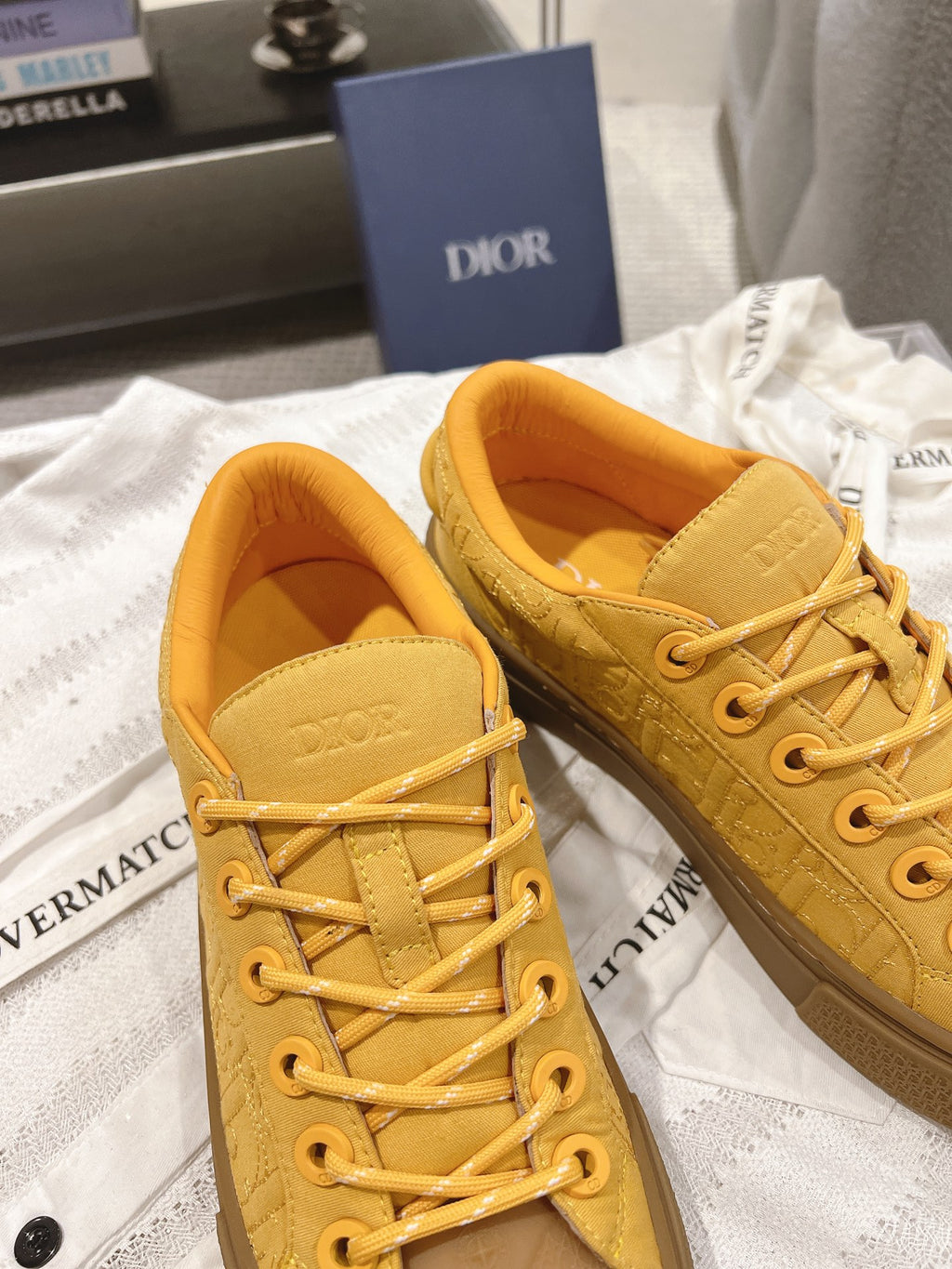 Yellow low-top unisex sneakers showing tongues and lace-up front