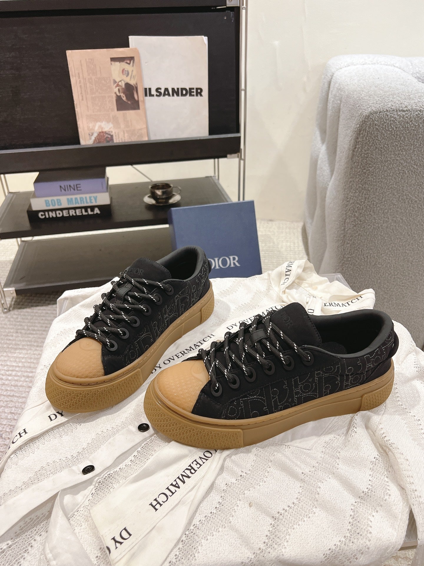 Black Dior sneakers with tan soles, lace-up design, side view