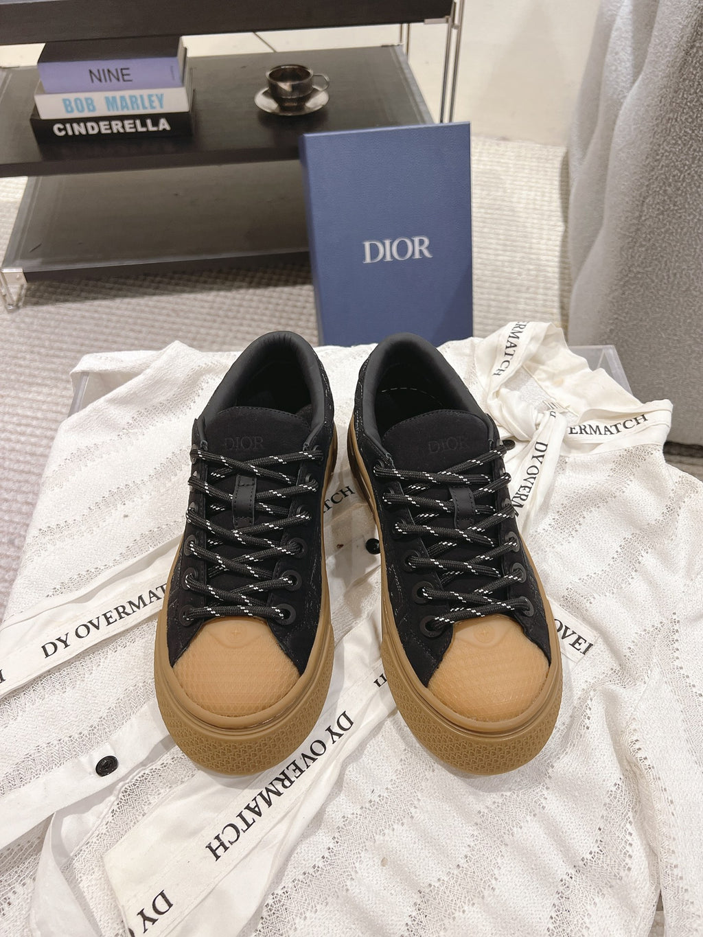 Black unisex Dior sneakers with tan sole and black lace-up front