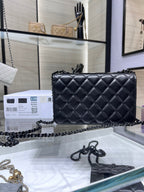 Black quilted leather flap crossbody bag with chain strap and front CC logo