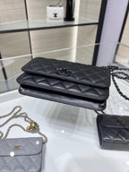 Black quilted leather flap bag with top foldover and chain strap on display