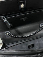 Black leather bag interior with zipper, CHANEL logo, and chain strap