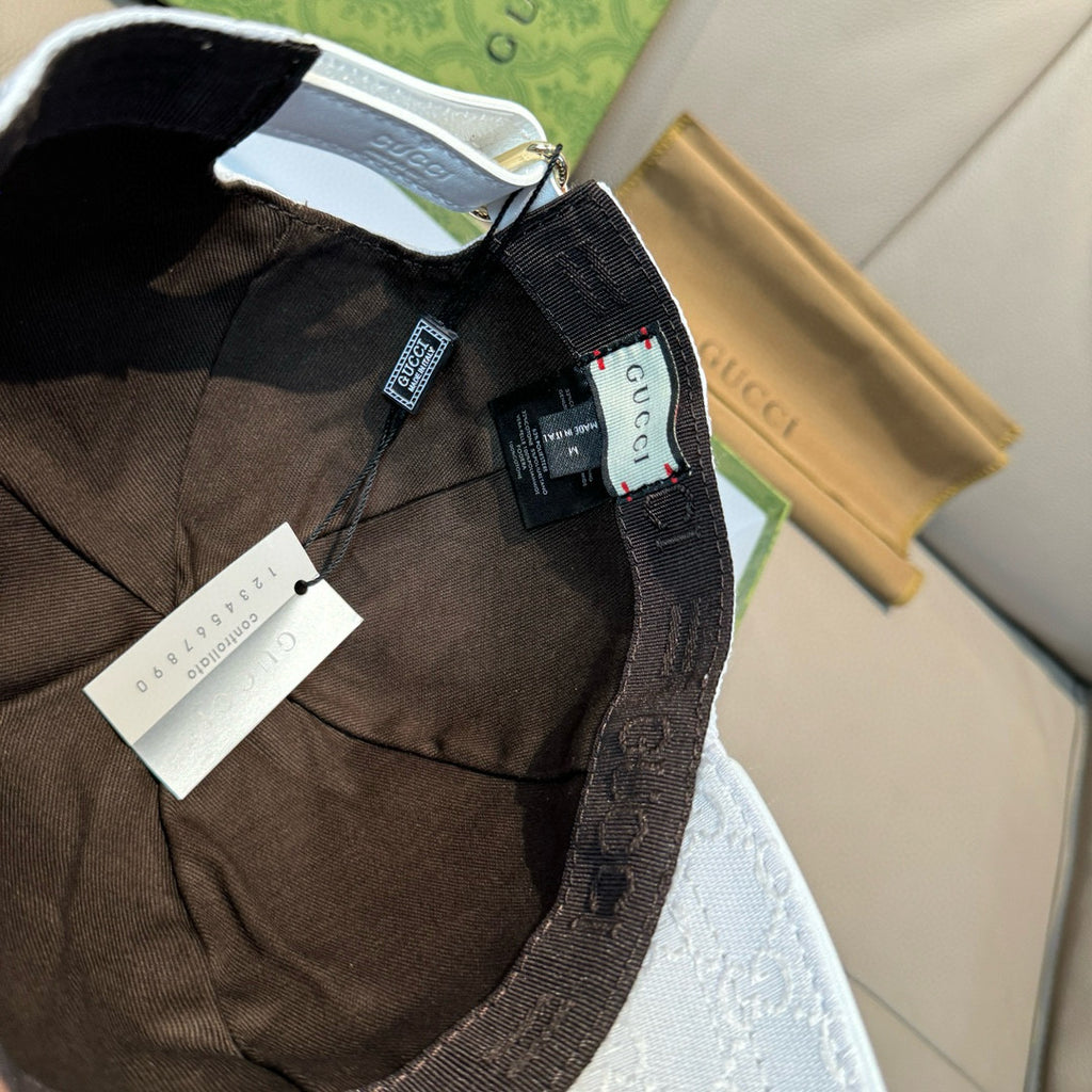 Interior view of dark fabric baseball cap with brand trim and adjustable strap