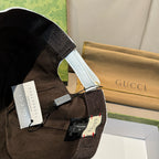 Dark Gucci baseball cap strap and interior detail with printed label