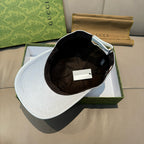 White Gucci monogram baseball cap with dark interior lining visible