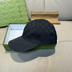 Gucci cap in dark GG monogram canvas with curved brim, front view.