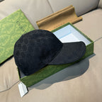 Gucci cap in dark GG monogram canvas, side profile view.