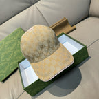 Gucci cap in beige GG monogram canvas with curved brim and stitched crown.