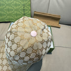 Gucci cap front view in beige GG monogram canvas with pink round top button.