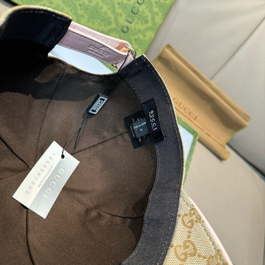 Gucci cap with brown GG monogram panel and black adjustable strap, with tags.