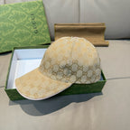 Gucci cap in beige GG monogram canvas with curved brim, displayed on a box.