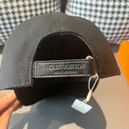 Black Louis Vuitton cap with LV label on adjustable back strap