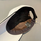 White Louis Vuitton cap with black inner brim and brown fabric lining