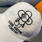 White Louis Vuitton cap close-up: black dog graphic and "Forever" embroidered text