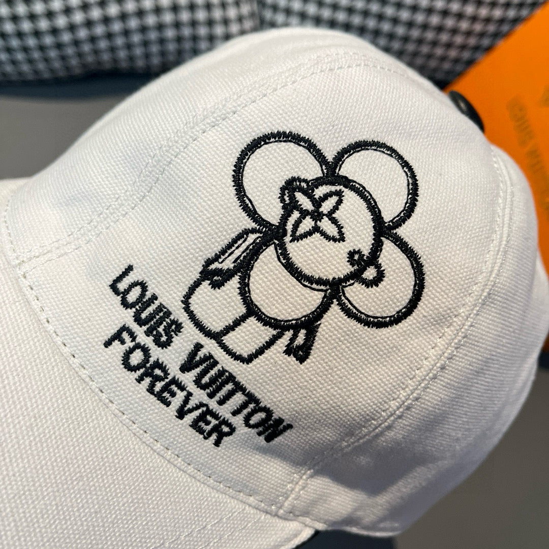 White Louis Vuitton cap close-up: black dog graphic and "Forever" embroidered text