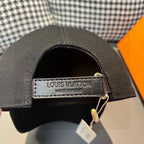 Black Louis Vuitton cap with tan interior label patch and adjustable strap
