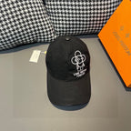 Black Louis Vuitton baseball cap with white embroidered flower logo on the side