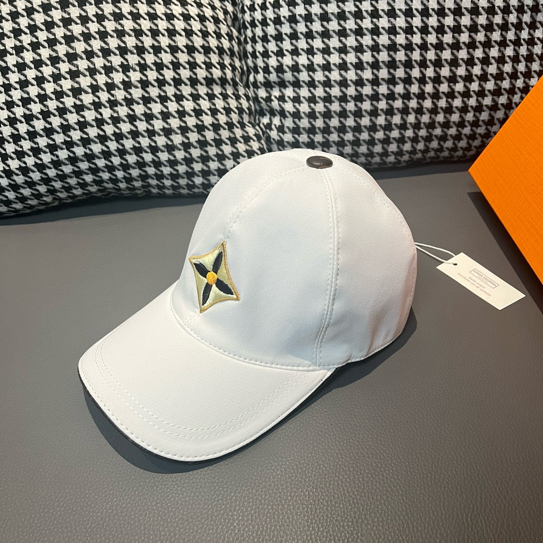 Louis Vuitton white baseball cap with embroidered star emblem, side view