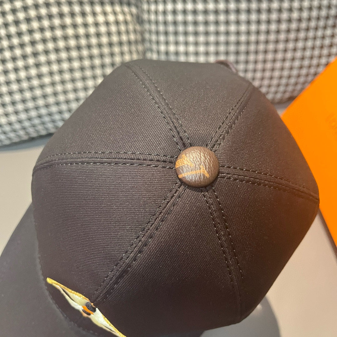 Louis Vuitton cap back view with top button and curved stitched panels on dark fabric.