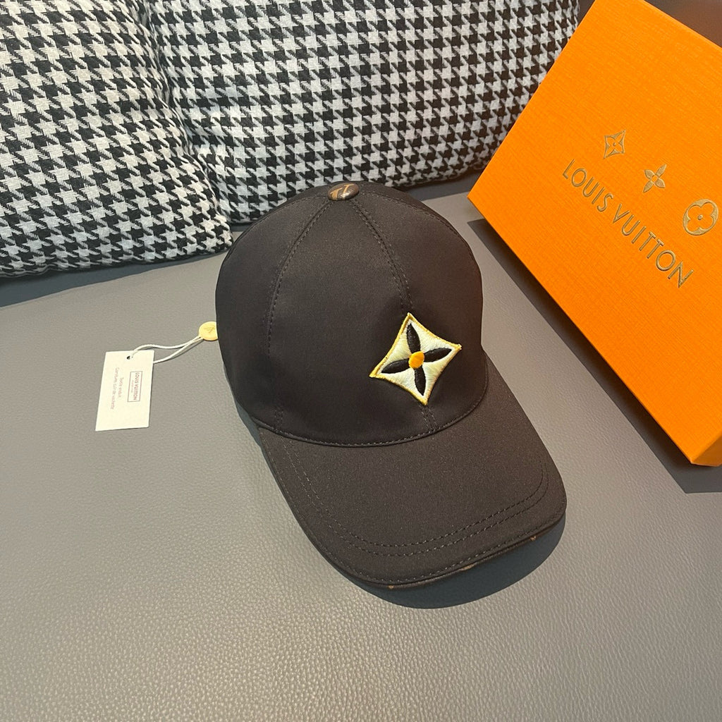 Louis Vuitton cap in dark fabric with yellow-and-black emblem on the side.