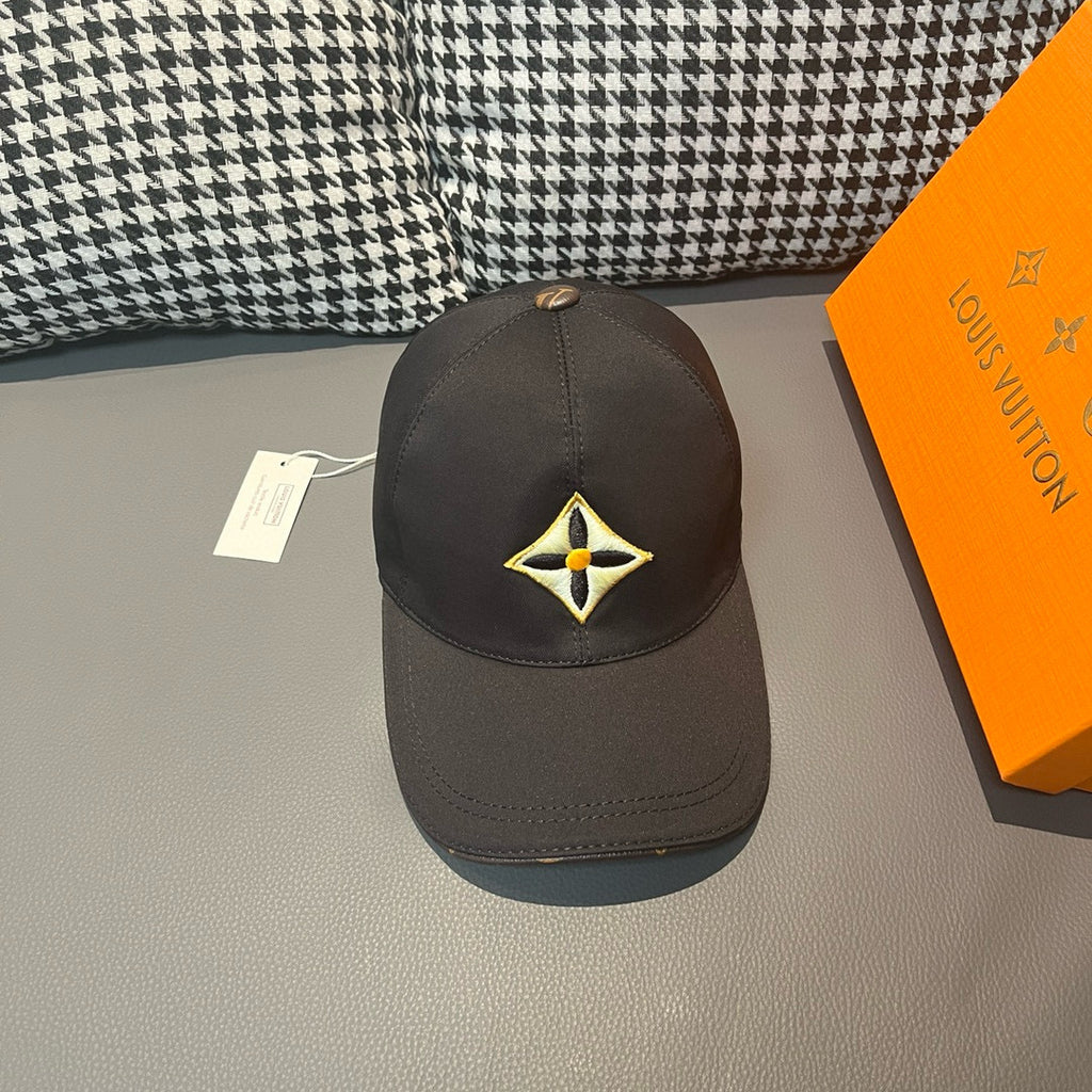 Louis Vuitton cap in dark fabric with yellow-and-black emblem front panel.