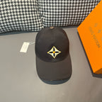 Louis Vuitton cap in dark fabric with yellow-and-black emblem front panel.