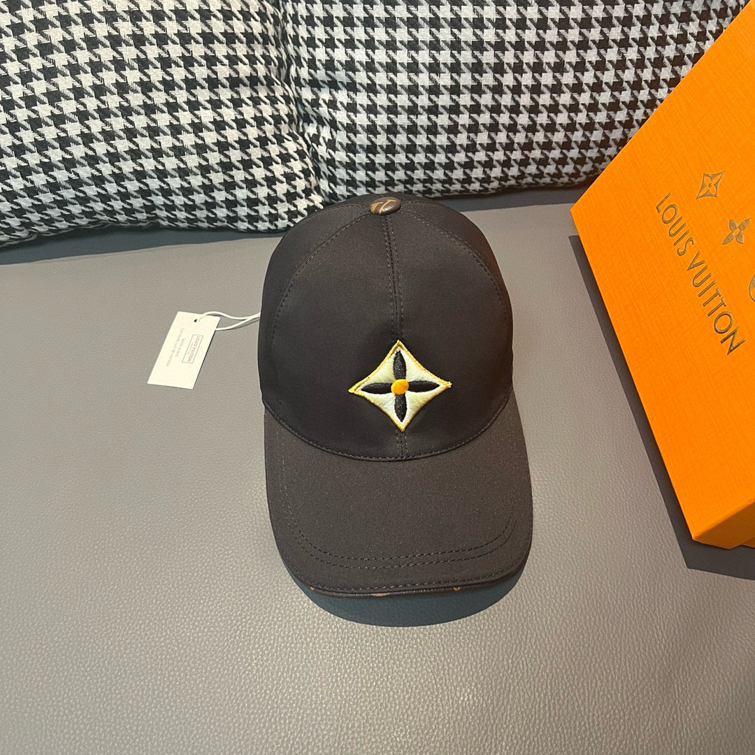 Louis Vuitton cap in dark fabric with yellow-and-black emblem front panel.
